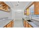 Kitchen with granite counters, stainless steel appliances and wood cabinetry with dining area at 3350 S Osprey Ave # 211A, Sarasota, FL 34239