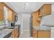 Bright kitchen with granite counters, wood cabinets, stainless steel appliances, and tiled floor at 3350 S Osprey Ave # 211A, Sarasota, FL 34239