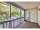 Relaxing screened lanai with brick floor offers a view of the lush, tropical foliage at 3350 S Osprey Ave # 211A, Sarasota, FL 34239
