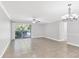 Bright living room with tile floor, ceiling fan and sliding glass doors to lanai at 3350 S Osprey Ave # 211A, Sarasota, FL 34239