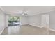 Open living room with tile flooring, ceiling fan, and access to a private lanai at 3350 S Osprey Ave # 211A, Sarasota, FL 34239