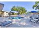 Inviting community pool area with lounge chairs and tables surrounded by lush landscaping at 3350 S Osprey Ave # 211A, Sarasota, FL 34239