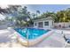 Refreshing community pool with clear water, surrounded by lounge chairs and a pool house at 3350 S Osprey Ave # 211A, Sarasota, FL 34239