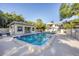 Community pool featuring a bath house, lounge seating and beautiful mature landscaping at 3350 S Osprey Ave # 211A, Sarasota, FL 34239