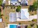 Bird's eye view of home with white roof, adjacent home with pool, and backyard at 3427 Cambridge Dr, Sarasota, FL 34232