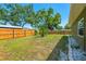 Fenced backyard with mature trees and a well-maintained lawn at 3427 Cambridge Dr, Sarasota, FL 34232