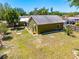 Spacious backyard featuring a well-maintained lawn, mature trees, and white rock landscaping at 3427 Cambridge Dr, Sarasota, FL 34232
