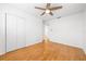 Clean and bright bedroom with gleaming wood floors, closet, and ceiling fan at 3427 Cambridge Dr, Sarasota, FL 34232