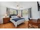 Bedroom featuring hardwood floors, a ceiling fan, and a large window at 3427 Cambridge Dr, Sarasota, FL 34232