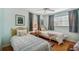 Bright bedroom featuring two twin beds, hardwood floors, and tropical-themed decor at 3427 Cambridge Dr, Sarasota, FL 34232