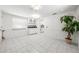 Bright dining area featuring tiled floors, white walls, and a large decorative potted plant at 3427 Cambridge Dr, Sarasota, FL 34232