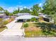 Charming single-story home with a well-manicured lawn and a long driveway at 3427 Cambridge Dr, Sarasota, FL 34232