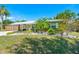The house features a metal roof, a lush yard, and a cozy carport at 3427 Cambridge Dr, Sarasota, FL 34232