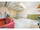 Garage interior featuring overhead door, side door, and storage at 3427 Cambridge Dr, Sarasota, FL 34232