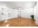 Bright living room features hardwood floors, ceiling fan, and access to the kitchen and bedrooms at 3427 Cambridge Dr, Sarasota, FL 34232