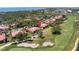 An aerial view shows this condominium complex on a golf course near the water in a serene setting at 3500 El Conquistador Pkwy # 117, Bradenton, FL 34210