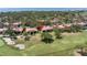 Scenic aerial view of the condominium complex nestled on a golf course, near the bay with mature trees at 3500 El Conquistador Pkwy # 117, Bradenton, FL 34210