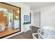 Balcony with white furniture and a view into the bedroom that leads to living room at 3500 El Conquistador Pkwy # 117, Bradenton, FL 34210