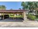 Covered carport with parking spots 115 and 117 with landscaping, adjacent to the villa at 3500 El Conquistador Pkwy # 117, Bradenton, FL 34210