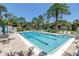 Community pool surrounded by lush greenery and seating areas providing a serene setting at 3500 El Conquistador Pkwy # 117, Bradenton, FL 34210