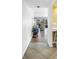 Inviting hallway with tile flooring, leading to a living area with large windows and outdoor views of the community at 3500 El Conquistador Pkwy # 117, Bradenton, FL 34210