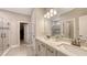 Bathroom features a double vanity, modern fixtures, updated cabinets, and tiled walk-in shower at 3803 Savanna Palms Ct, Bradenton, FL 34211