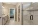 Bathroom features a double vanity, modern fixtures, updated cabinets, and tiled walk-in shower at 3803 Savanna Palms Ct, Bradenton, FL 34211