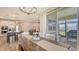 Spacious dining area with modern light fixture that flows to the lanai and open kitchen at 3803 Savanna Palms Ct, Bradenton, FL 34211