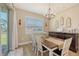 Elegant dining room features a wood table, chandelier, and sliding glass doors at 3803 Savanna Palms Ct, Bradenton, FL 34211