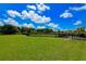Large community green space designated as a dog park, enclosed with a fence for safe play at 3803 Savanna Palms Ct, Bradenton, FL 34211
