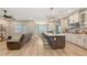 Open-concept kitchen with granite countertops, stainless steel appliances, and a center island with seating at 3803 Savanna Palms Ct, Bradenton, FL 34211