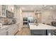 Bright kitchen boasts stainless steel appliances, herringbone backsplash, and large island at 3803 Savanna Palms Ct, Bradenton, FL 34211