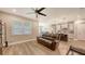 Bright living area with wood floors, an open floor plan, and modern kitchen views at 3803 Savanna Palms Ct, Bradenton, FL 34211