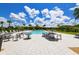 Community pool area with tables, chairs, and umbrellas at 3803 Savanna Palms Ct, Bradenton, FL 34211