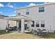 Backyard view featuring a covered patio, outdoor furniture, and a well-maintained lawn at 3813 Lively Coral Pl, Bradenton, FL 34208