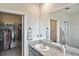 Bathroom with granite counters, modern fixtures, and a walk-in closet at 3813 Lively Coral Pl, Bradenton, FL 34208