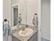 Bathroom featuring a granite countertop, oval sink, and decorative towels on dark towel rings at 3813 Lively Coral Pl, Bradenton, FL 34208
