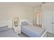 Cozy bedroom with two twin beds, side tables, and natural light filtering through a window at 3813 Lively Coral Pl, Bradenton, FL 34208