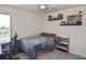 Bedroom with ceiling fan, desk and gaming chair, shelving and decorated display shelves at 3813 Lively Coral Pl, Bradenton, FL 34208