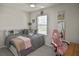 Bedroom featuring a ceiling fan, neutral décor, and a comfortable bed setting at 3813 Lively Coral Pl, Bradenton, FL 34208