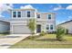 Charming two-story home with a well-manicured lawn and a two-car garage at 3813 Lively Coral Pl, Bradenton, FL 34208