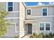 Front entry of a two-story home with a gray front door and attractive stone accents at 3813 Lively Coral Pl, Bradenton, FL 34208