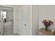 Hallway with view into carpeted bedroom, light gray walls, white trim and paneled doors at 3813 Lively Coral Pl, Bradenton, FL 34208