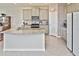 Bright open kitchen features gray cabinets, stainless appliances, granite counters and tile flooring at 3813 Lively Coral Pl, Bradenton, FL 34208