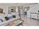 Open-concept living room featuring a view of the kitchen, dining room, and staircase at 3813 Lively Coral Pl, Bradenton, FL 34208