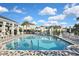 Inviting community pool area featuring comfortable lounge chairs and a modern pool house at 3813 Lively Coral Pl, Bradenton, FL 34208