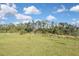 Expansive backyard with verdant grass and plenty of room to build the outdoor space of your dreams at 3836 Wenona Dr, North Port, FL 34288