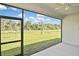Screened patio offers an expansive view of the lush green backyard at 3836 Wenona Dr, North Port, FL 34288