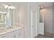 Bathroom featuring double sink vanity with marble countertop and tiled walk-in shower at 3836 Wenona Dr, North Port, FL 34288