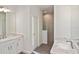 Bathroom featuring double sink vanity with marble countertop and tiled walk-in shower at 3836 Wenona Dr, North Port, FL 34288